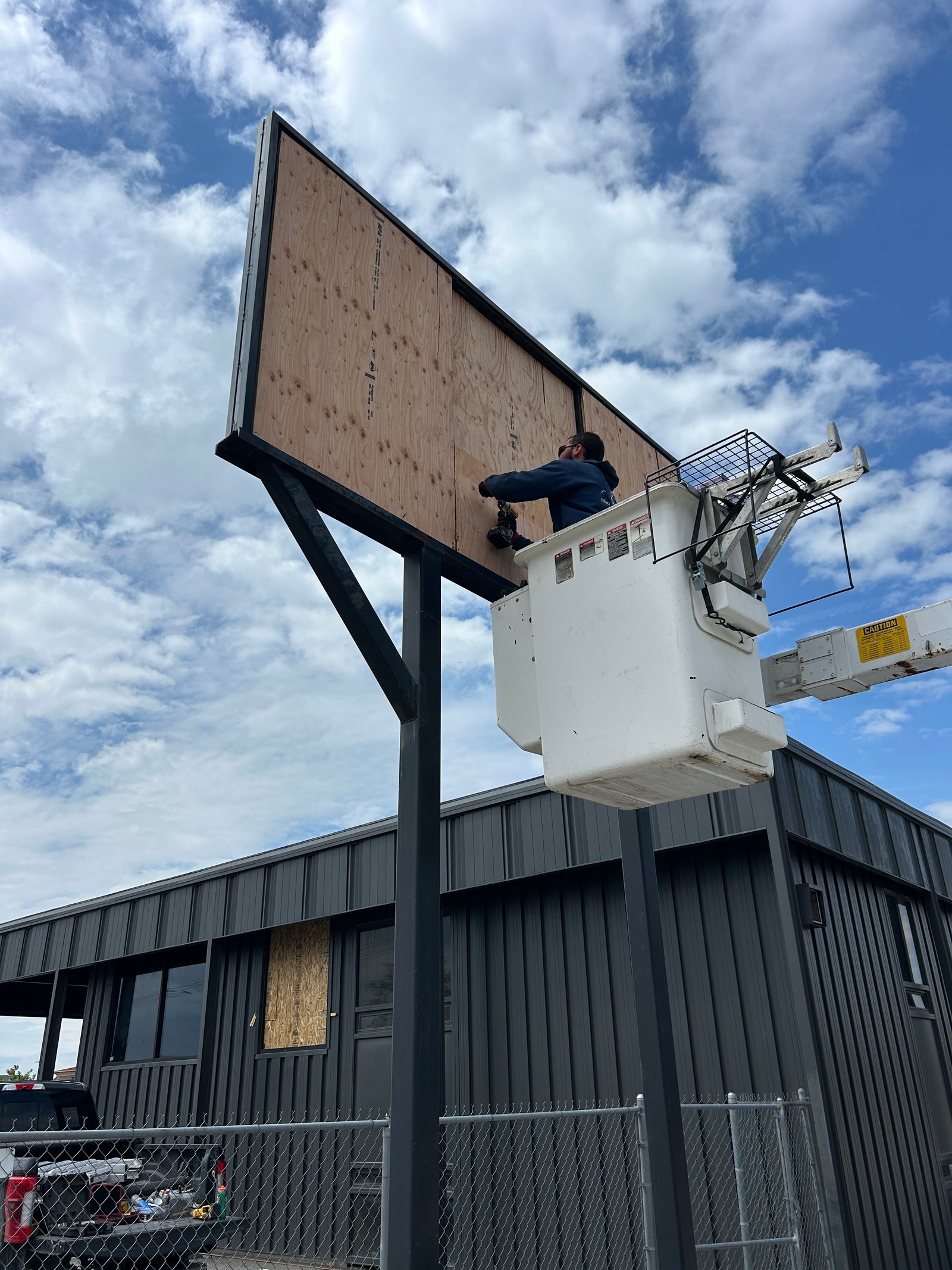 Sign installation from a bucket truck